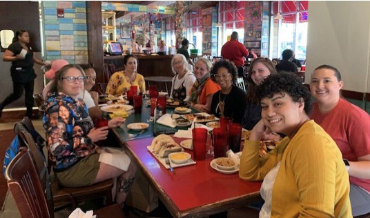 people looking at camera from table