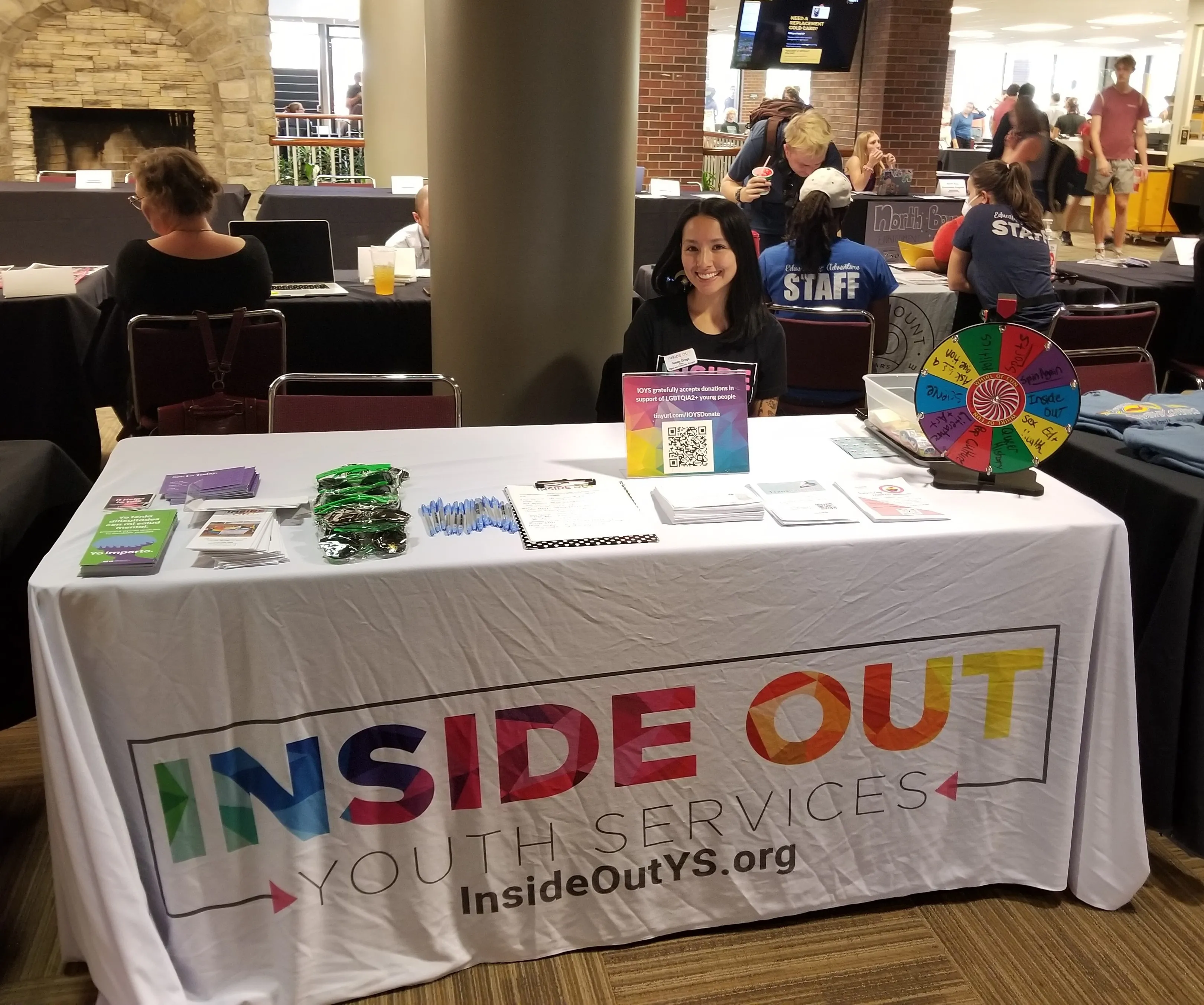 Student volunteer at table for Inside Out Youth Services