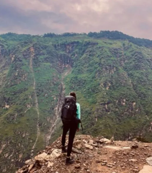 Person with backpack on mountaintop